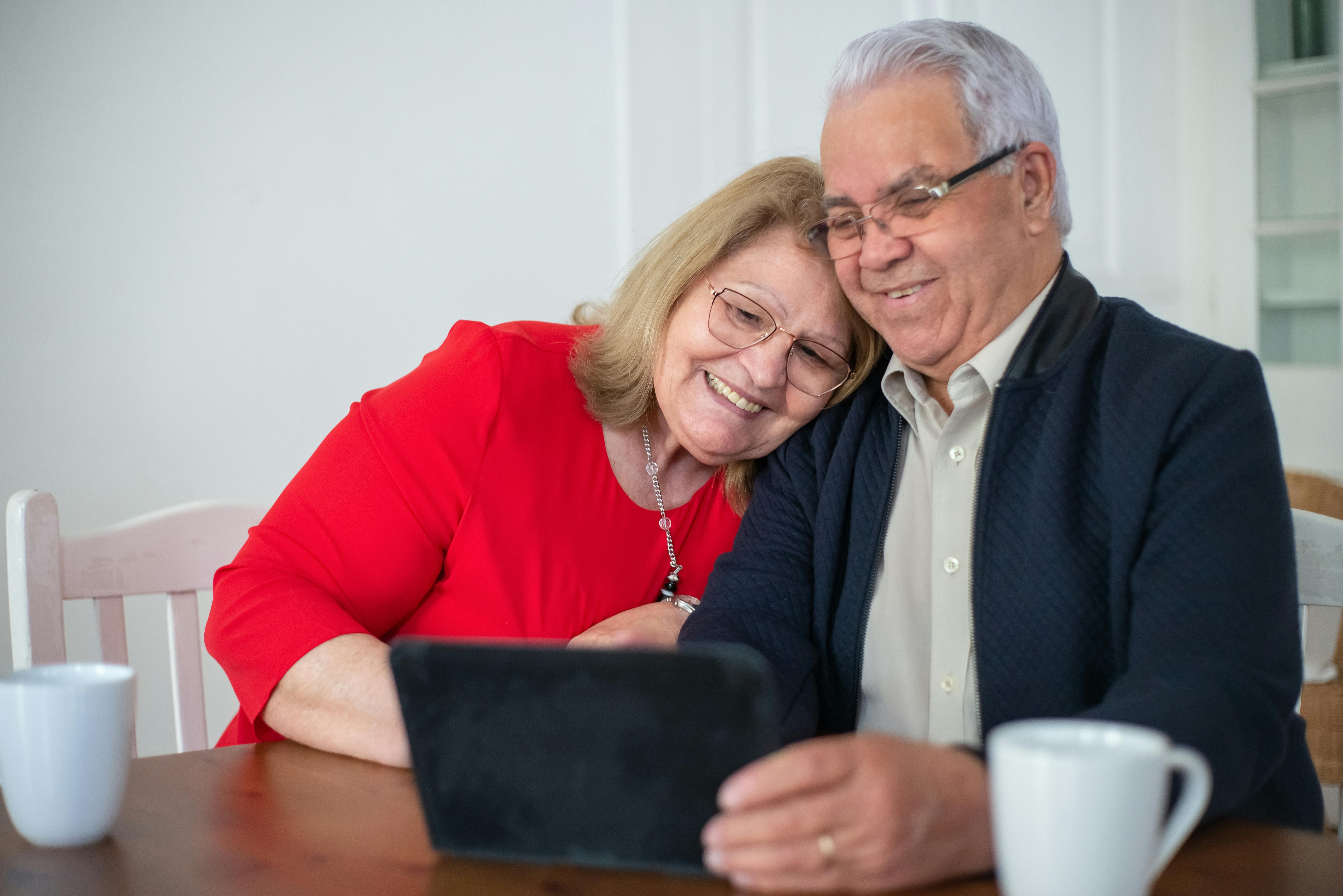 Happy couple reviewing Medicare options with an agent